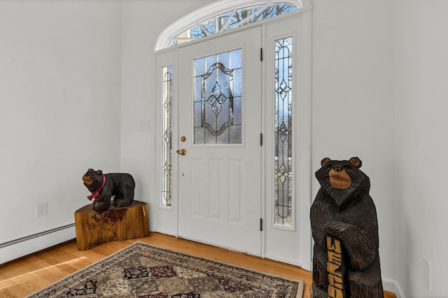 entryway featuring a baseboard radiator and wood finished floors