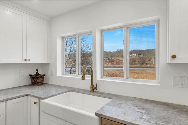 kitchen with a sink and white cabinetry