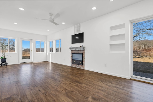 unfurnished living room with dark wood-type flooring, ceiling fan, and recessed lighting