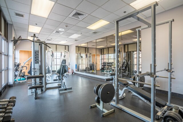 workout area featuring a drop ceiling and visible vents