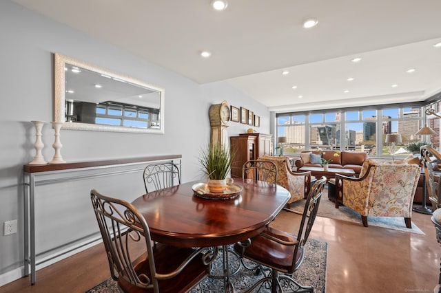 dining area with finished concrete floors, a view of city, and recessed lighting