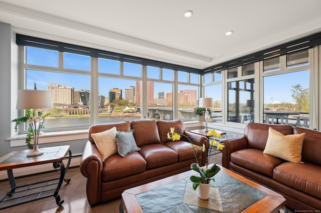 sunroom featuring a city view and recessed lighting