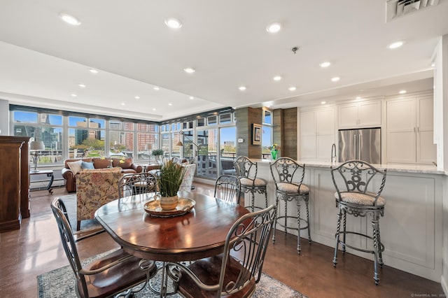 dining area with recessed lighting, finished concrete flooring, a healthy amount of sunlight, and visible vents