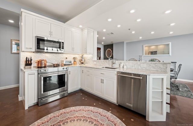 kitchen featuring appliances with stainless steel finishes, baseboards, and recessed lighting