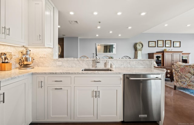 kitchen featuring white cabinetry, visible vents, a sink, and dishwasher