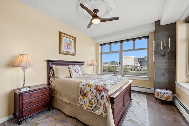 bedroom with finished concrete floors, ceiling fan, and a baseboard heating unit