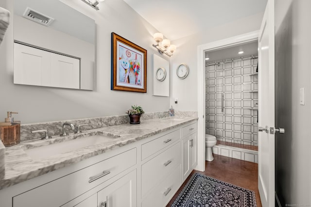 full bath featuring a sink, double vanity, toilet, and visible vents