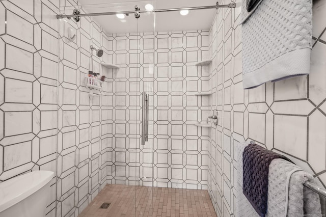 full bath with a shower stall and toilet