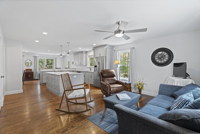 living room with recessed lighting, baseboards, a ceiling fan, and dark wood finished floors