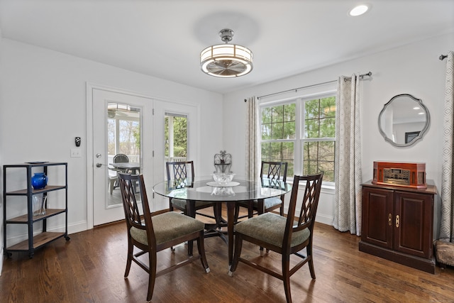 dining area with dark wood-style floors and baseboards