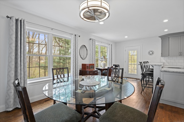 dining room with recessed lighting, dark wood-style flooring, and baseboards