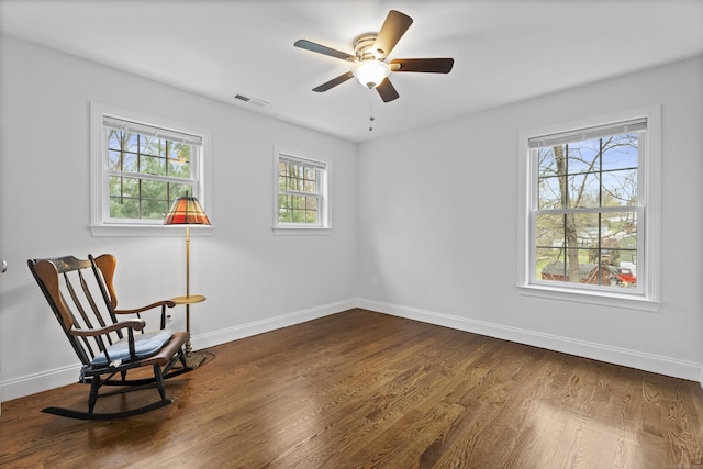 unfurnished room with baseboards, dark wood finished floors, and ceiling fan