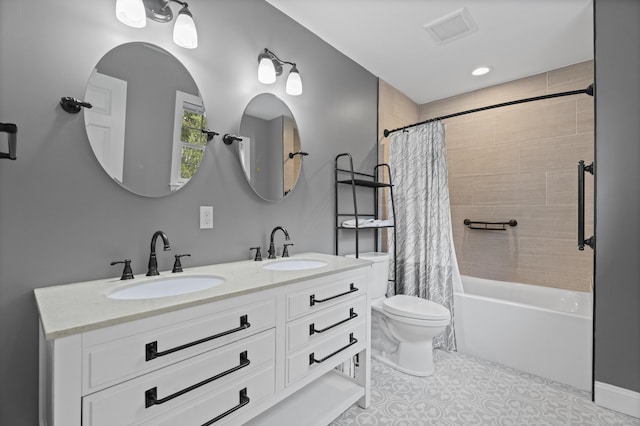 full bath featuring toilet, shower / bath combo with shower curtain, double vanity, and tile patterned floors