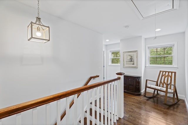 hall with attic access, dark wood-style flooring, an upstairs landing, recessed lighting, and baseboards