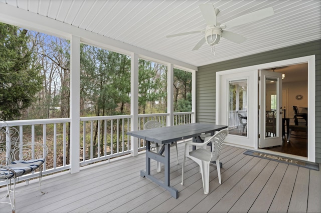 sunroom / solarium with ceiling fan and outdoor dining area