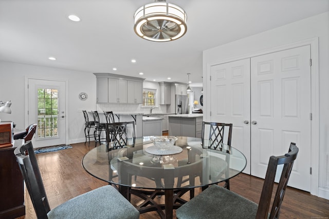 dining area featuring healthy amount of natural light, dark wood finished floors, recessed lighting, and baseboards