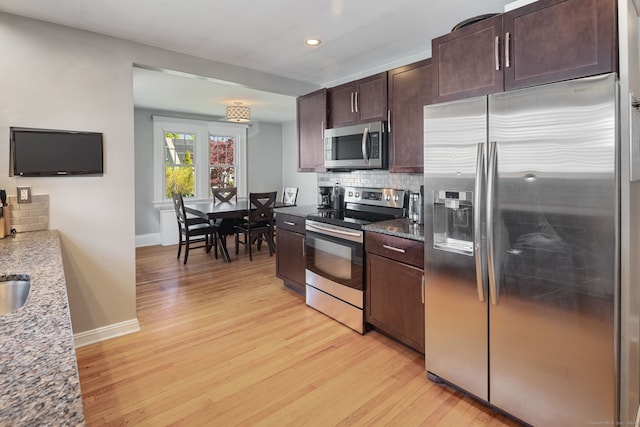43 Bibbins Ave, Fairfield, CT 06825 - kitchen featuring light wood-style floors, baseboards, tasteful backsplash, and stainless steel appliances