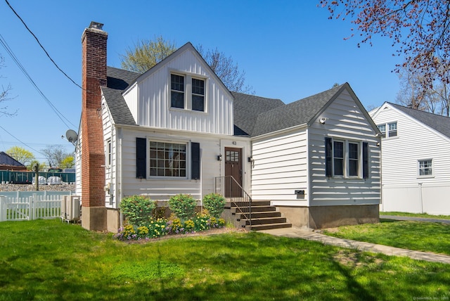 43 Bibbins Ave, Fairfield, CT 06825 - view of front of house with fence, a chimney, a shingled roof, and a front lawn