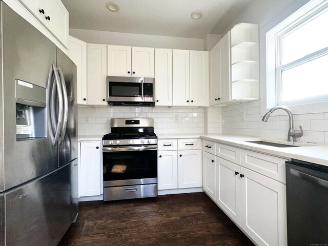 65 Beach St, Bridgeport, CT 06608 - kitchen featuring decorative backsplash, stainless steel appliances, light countertops, and a sink