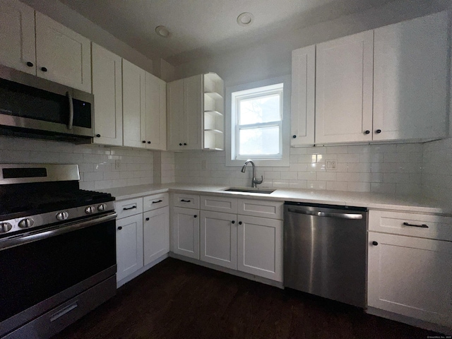 65 Beach St, Bridgeport, CT 06608 - kitchen featuring white cabinets, backsplash, stainless steel appliances, and a sink