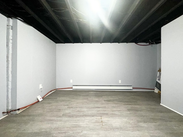 65 Beach St, Bridgeport, CT 06608 - finished basement featuring baseboards, wood finished floors, and a baseboard radiator
