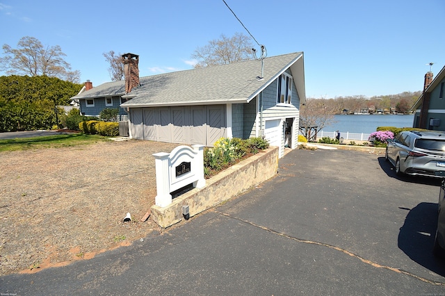 12 W Point Rd, East Hampton, CT 06424 - view of side of property with a water view and roof with shingles