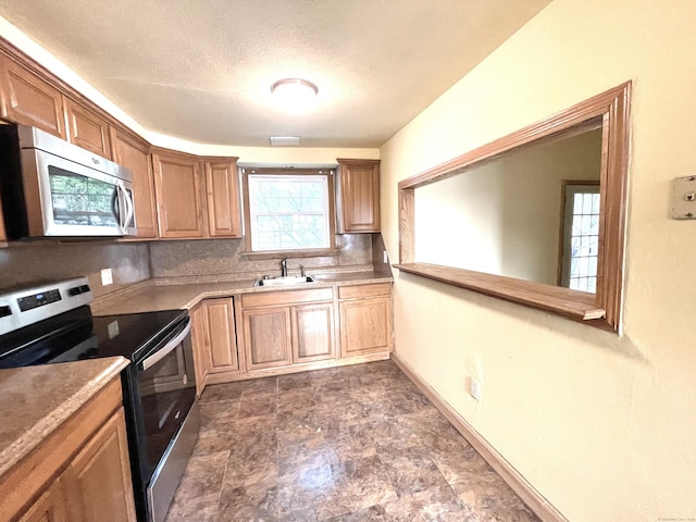 6 Stirling Ct, Middletown, CT 06457 - kitchen featuring tasteful backsplash, stainless steel appliances, stone finish floor, light countertops, and a sink