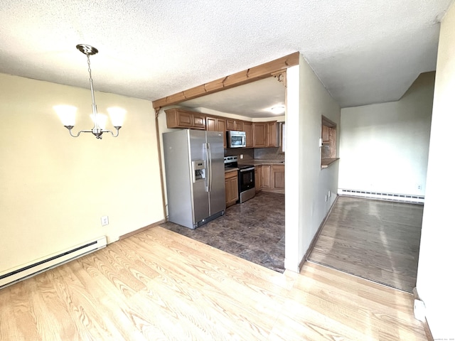 6 Stirling Ct, Middletown, CT 06457 - kitchen with baseboard heating, stainless steel appliances, a textured ceiling, and wood finished floors