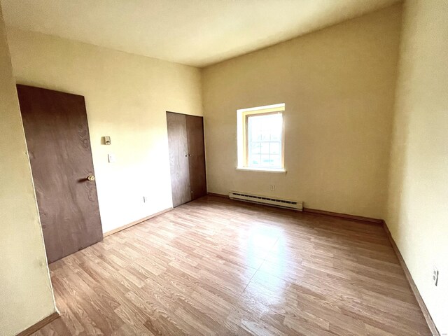 6 Stirling Ct, Middletown, CT 06457 - unfurnished bedroom featuring a baseboard radiator, wood finished floors, and baseboards