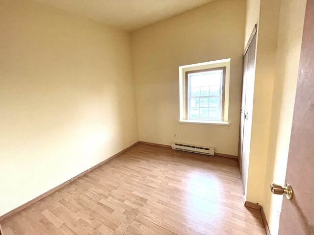 6 Stirling Ct, Middletown, CT 06457 - spare room with baseboard heating, light wood-style floors, and baseboards
