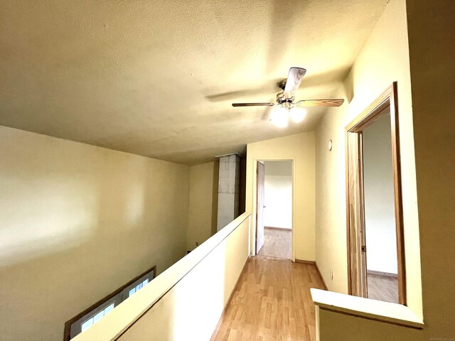 6 Stirling Ct, Middletown, CT 06457 - hallway featuring an upstairs landing, a textured ceiling, light wood-style floors, and vaulted ceiling