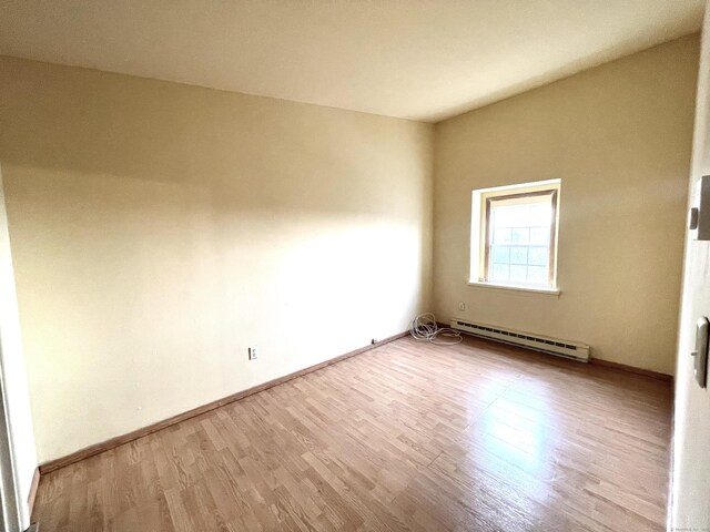 6 Stirling Ct, Middletown, CT 06457 - spare room with wood finished floors, a baseboard heating unit, and baseboards
