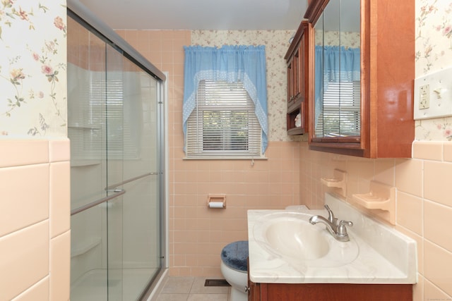 full bathroom with tile walls, a healthy amount of sunlight, and wallpapered walls