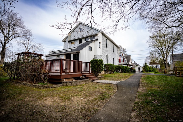 30 Merrimac St, Watertown, CT 06779 - view of home's exterior featuring a wooden deck and a lawn