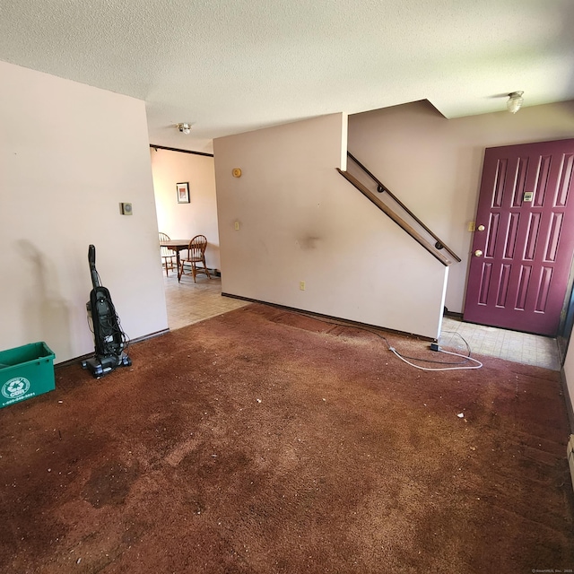 unfurnished living room with a textured ceiling