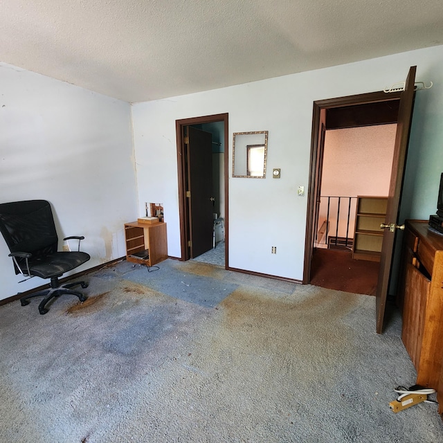 interior space with a textured ceiling and carpet