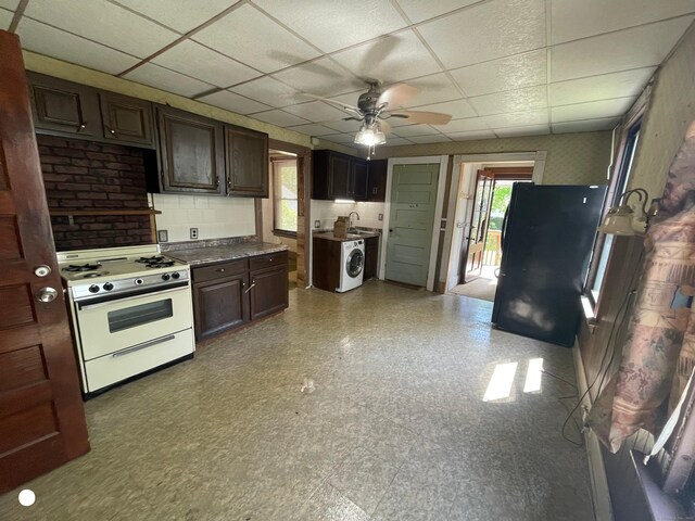 408 Blohm St, West Haven, CT 06516 - kitchen featuring a ceiling fan, tile patterned floors, white gas range oven, washer / dryer, and a drop ceiling