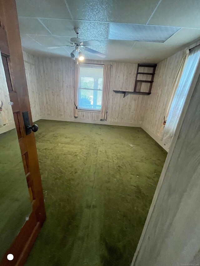 408 Blohm St, West Haven, CT 06516 - interior space with wood walls, a ceiling fan, and a drop ceiling