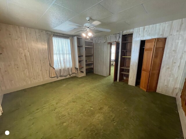 408 Blohm St, West Haven, CT 06516 - interior space with a ceiling fan and wood walls