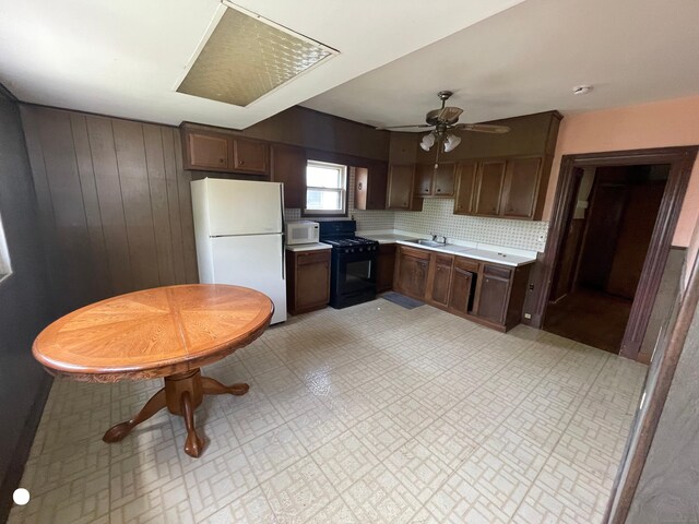 408 Blohm St, West Haven, CT 06516 - kitchen featuring dark brown cabinetry, a sink, white appliances, light countertops, and a ceiling fan