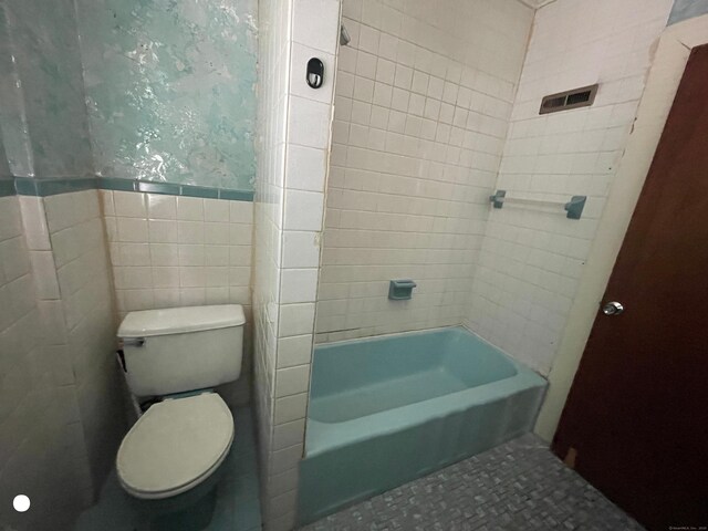 408 Blohm St, West Haven, CT 06516 - full bathroom with a wainscoted wall, toilet, and tile walls
