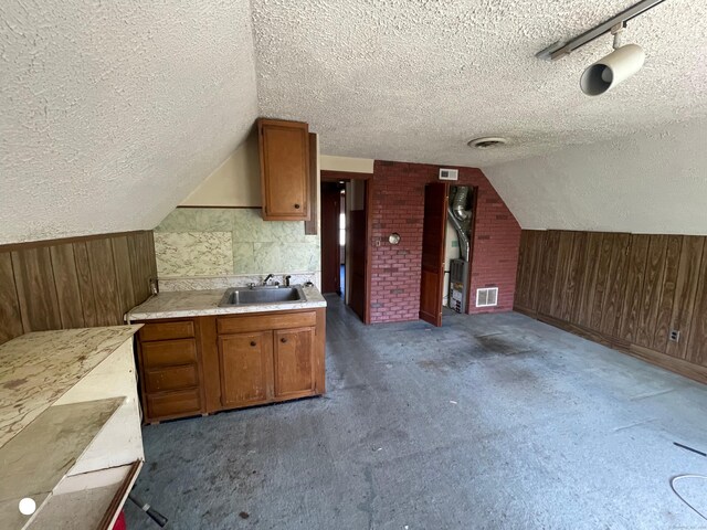 408 Blohm St, West Haven, CT 06516 - bonus room featuring a sink, wood walls, and a textured ceiling