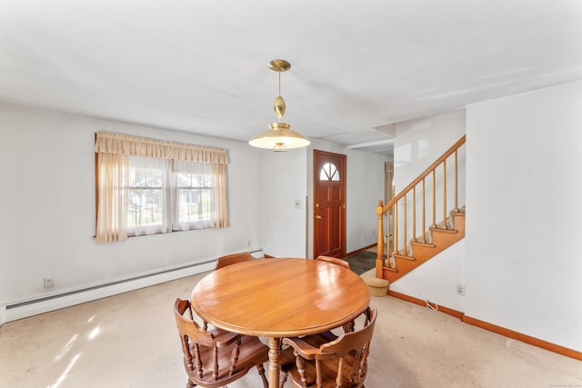 dining room featuring baseboards, baseboard heating, and stairway