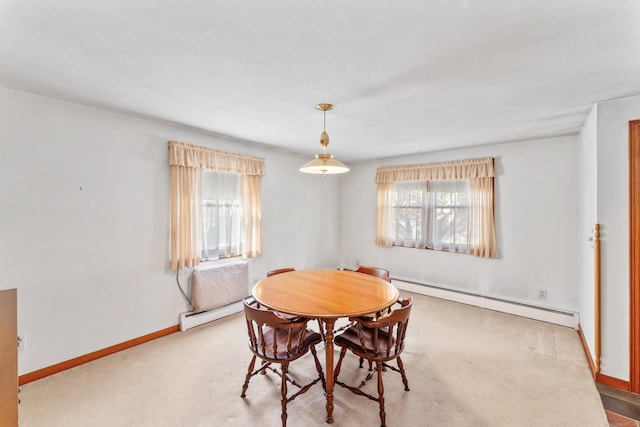 carpeted dining room with baseboards and baseboard heating