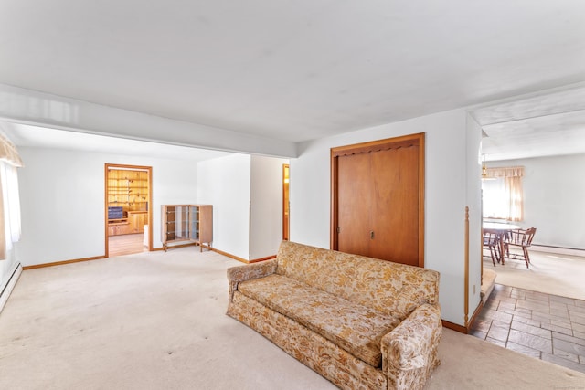 living area featuring carpet floors and baseboards