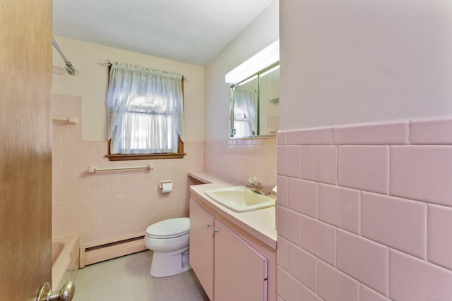 full bathroom with tile walls, tile patterned flooring, baseboard heating, vanity, and toilet