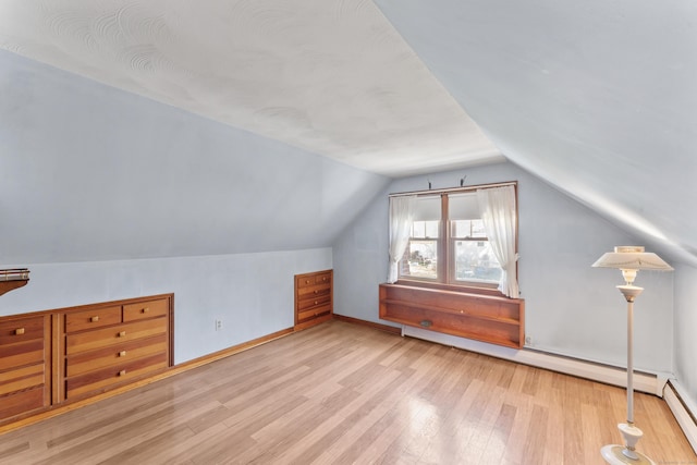 bonus room with baseboards, wood finished floors, and lofted ceiling