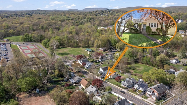 birds eye view of property featuring a wooded view