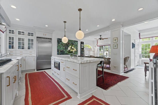 259 N Main St, Stonington, CT 06378 - kitchen featuring built in appliances, a kitchen island, white cabinets, ceiling fan, and recessed lighting