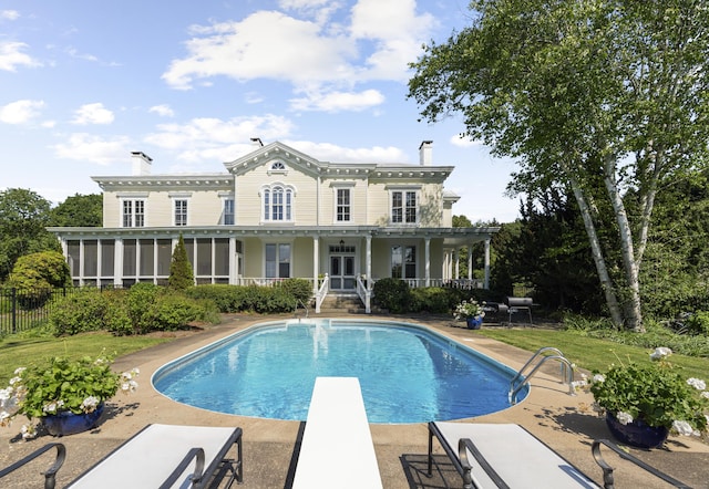 259 N Main St, Stonington, CT 06378 - back of house featuring a chimney, an outdoor pool, and a patio